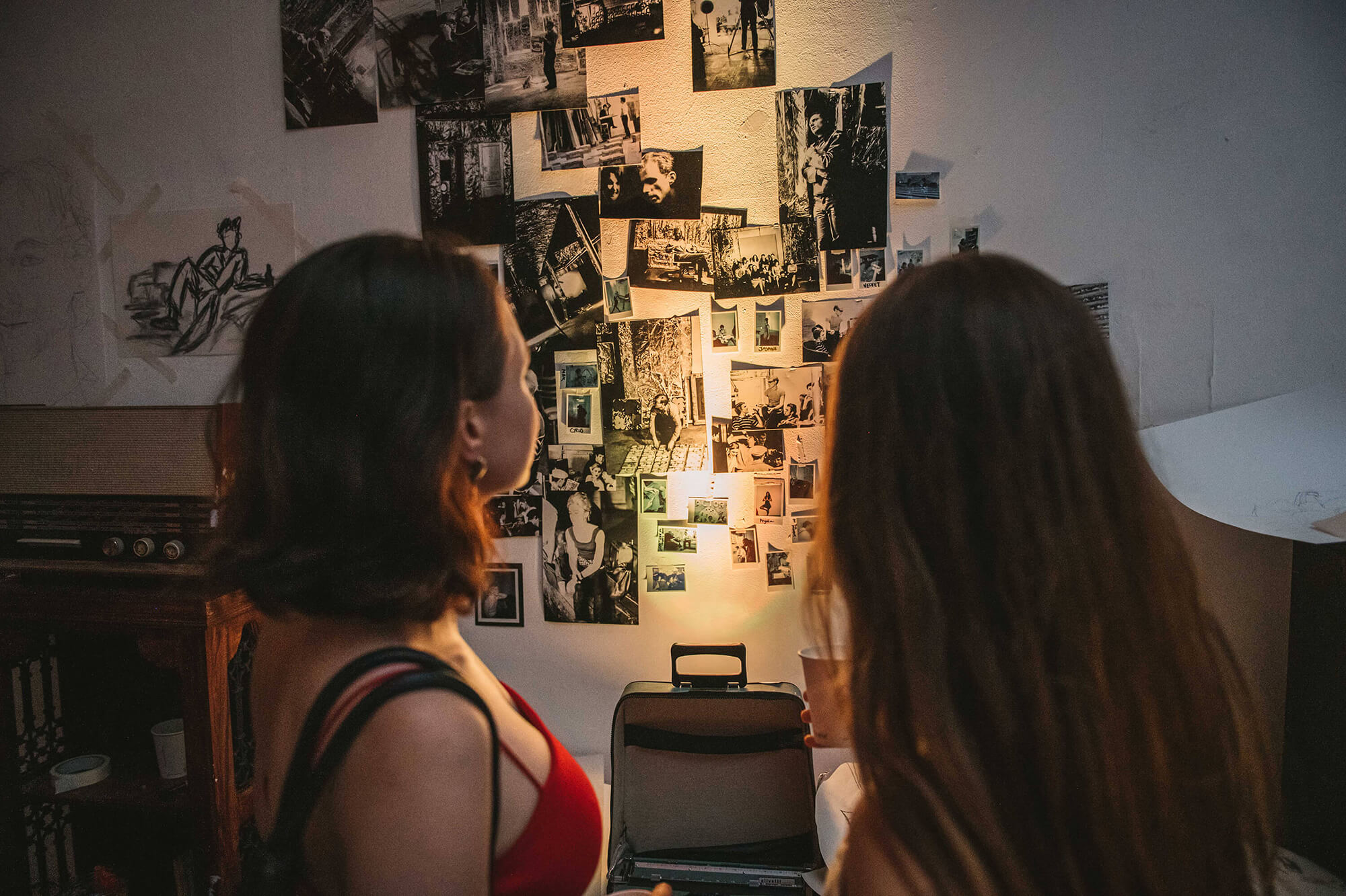 Two woman looking at photographs at City Night's Party at the Silver Factory, 1966